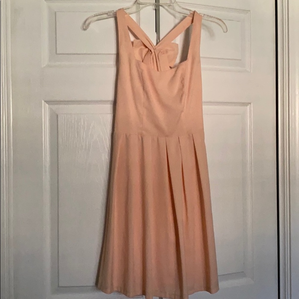 Bow-on-back cocktail dress with flattering pleats